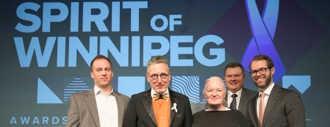 Photograph of Wins and Rae Bridgman accepting a 2019 Spirit of Winnipeg Award.